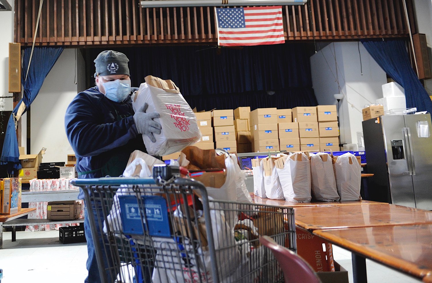 Mike Steinbeck, the cook for the Sullivan County Federation for the Homeless (SCFH), places bags of donated food into a shopping cart for transportation to the food shed, where the food is handed out during Friday’s food pantry program. That takes place from 11:30 a.m. to 1 p.m. The SCFH is located at 9 Monticello St. in Monticello.